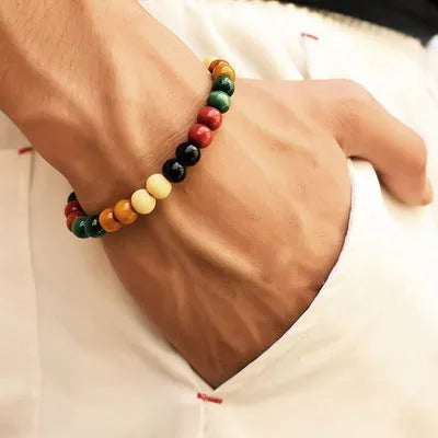 Natural stone beaded bracelet with lava stones on a wrist, showing ethnic style and unisex design.