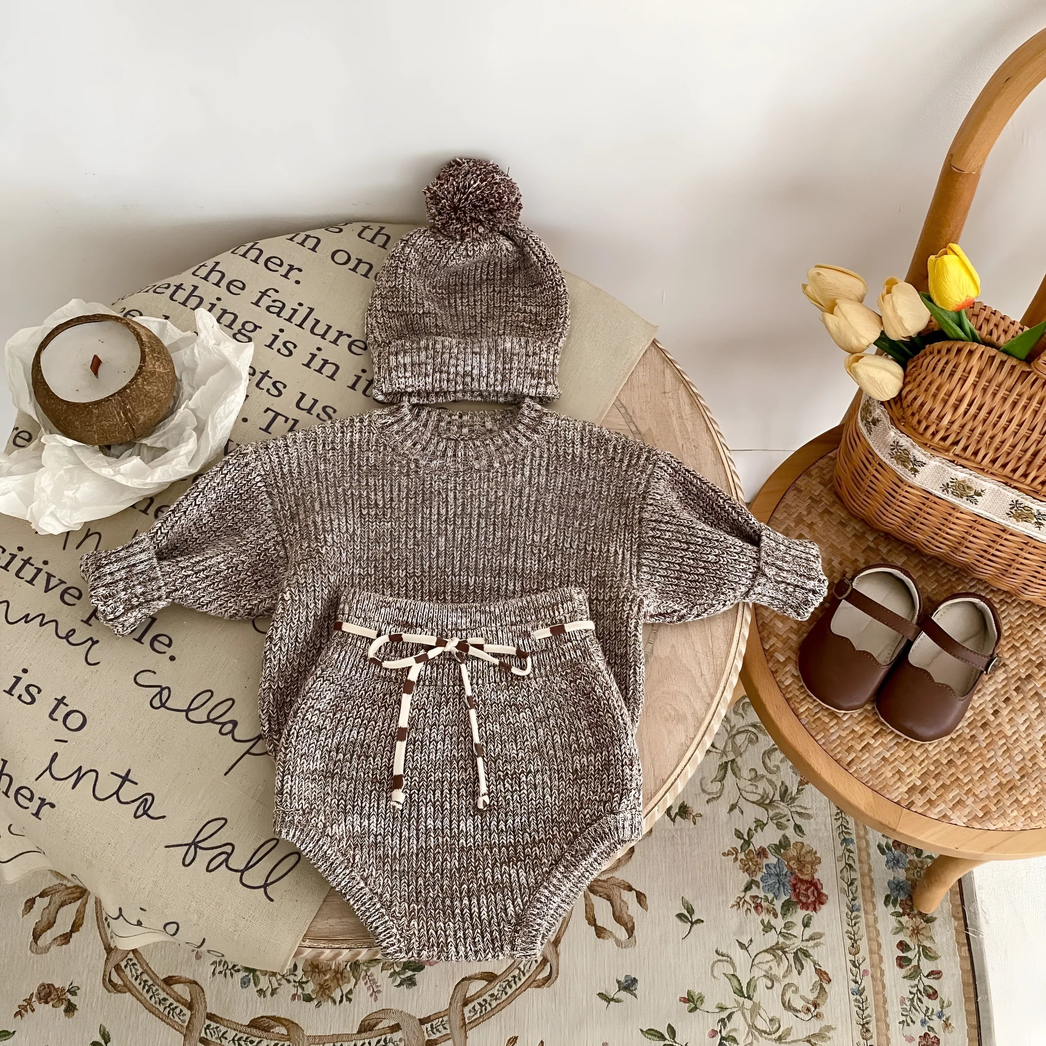 Dark brown knitted 3-piece set for infant girl with pullover blouse, pants, and fur ball hat
