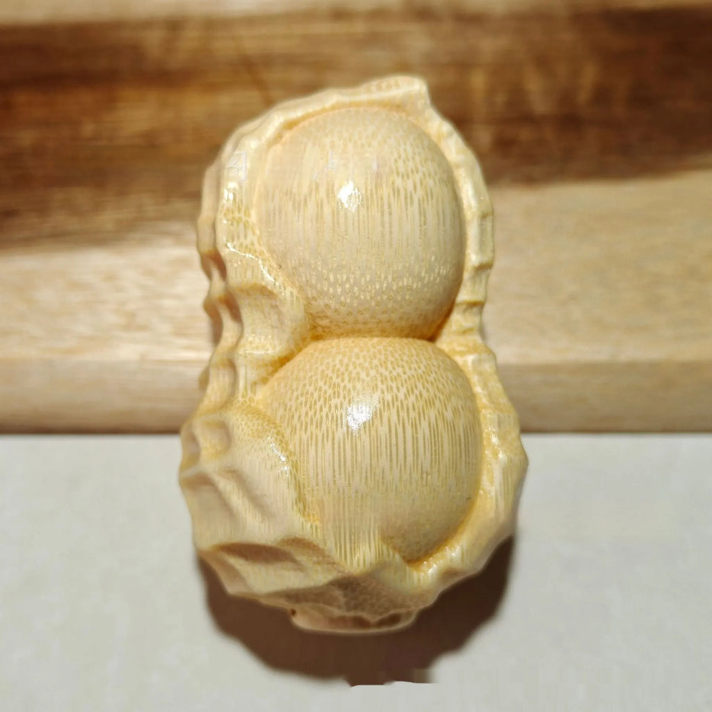Modern simplicity style solid bamboo carving peanut ornament on a neutral background.