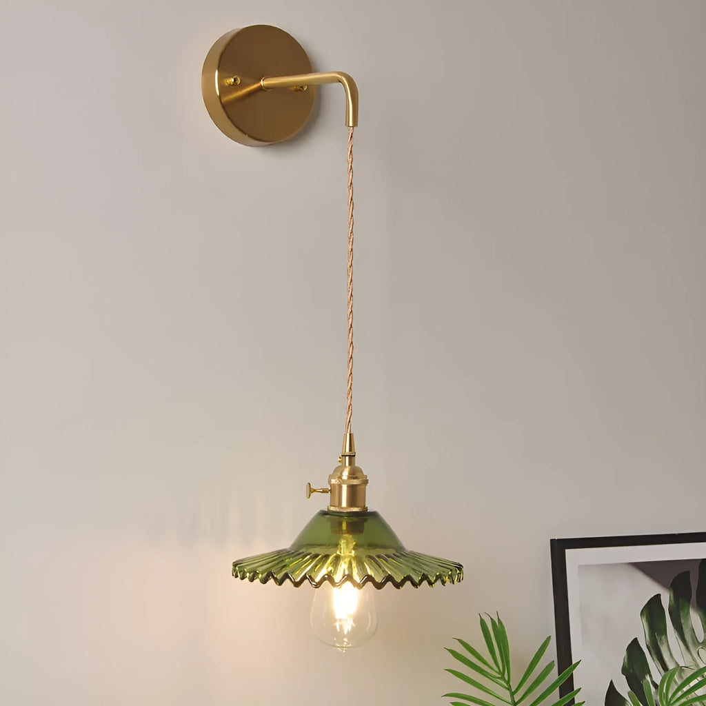 Retro brass lotus wall lamp with copper frame and glass shade on a wall