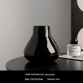 Ceramic vase with glass surface in black or white colour featuring coloured glaze finish and modern simple style