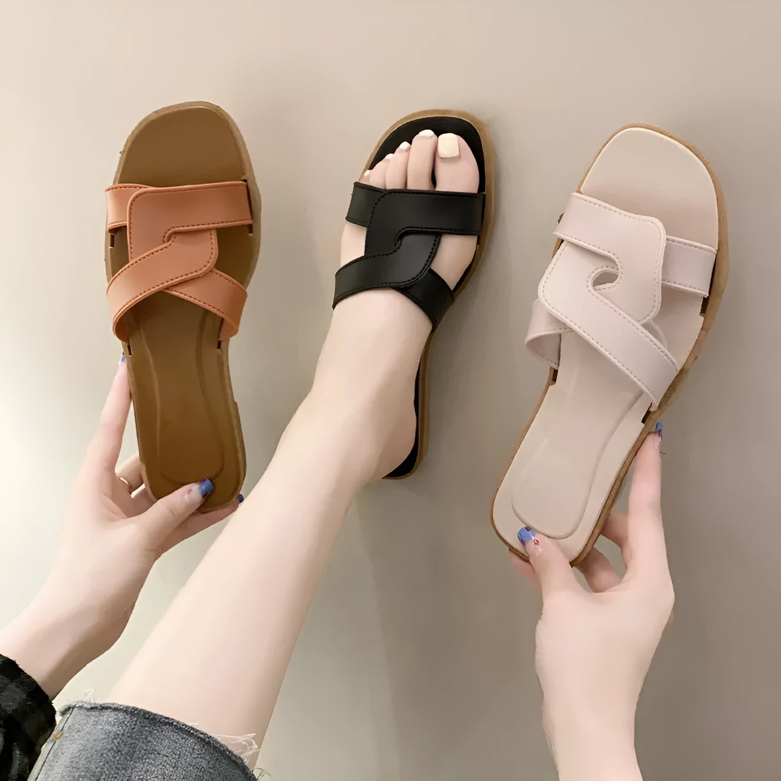 Women's PVC cross strap toe ring slipper in solid colour on a plain background.