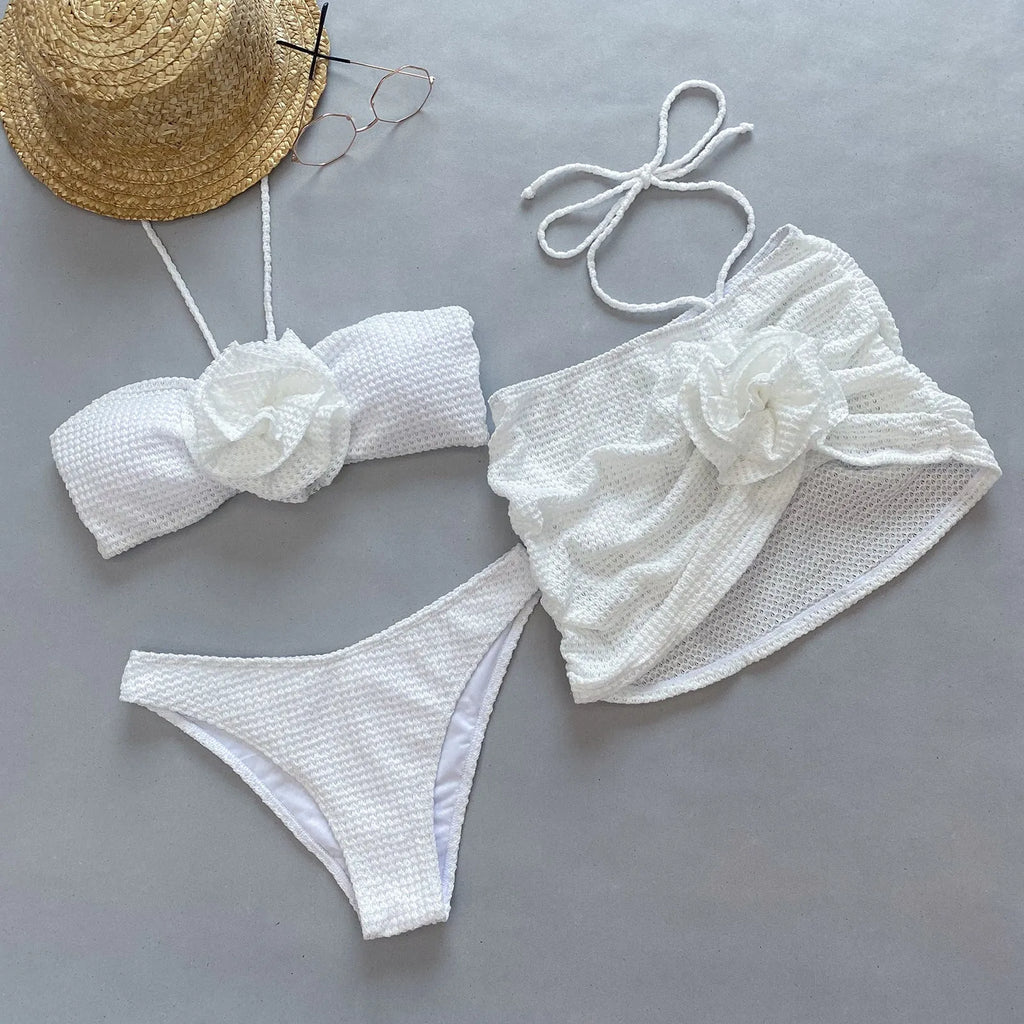 Women's 3D flower split three-piece bikini set in white or purple.