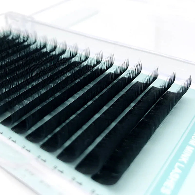 Artificial fibre false eyelashes on a card showing velvet texture and natural curl, with size options from 7mm to 15mm.