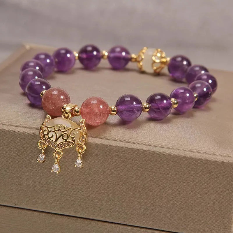 Women's handmade copper longevity lock bracelet with natural amethyst accents and safety lock charm