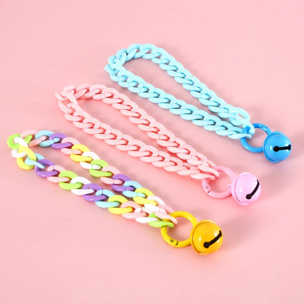 Macaron candy colour plastic collar for pet dog cat rabbit on a blue background.