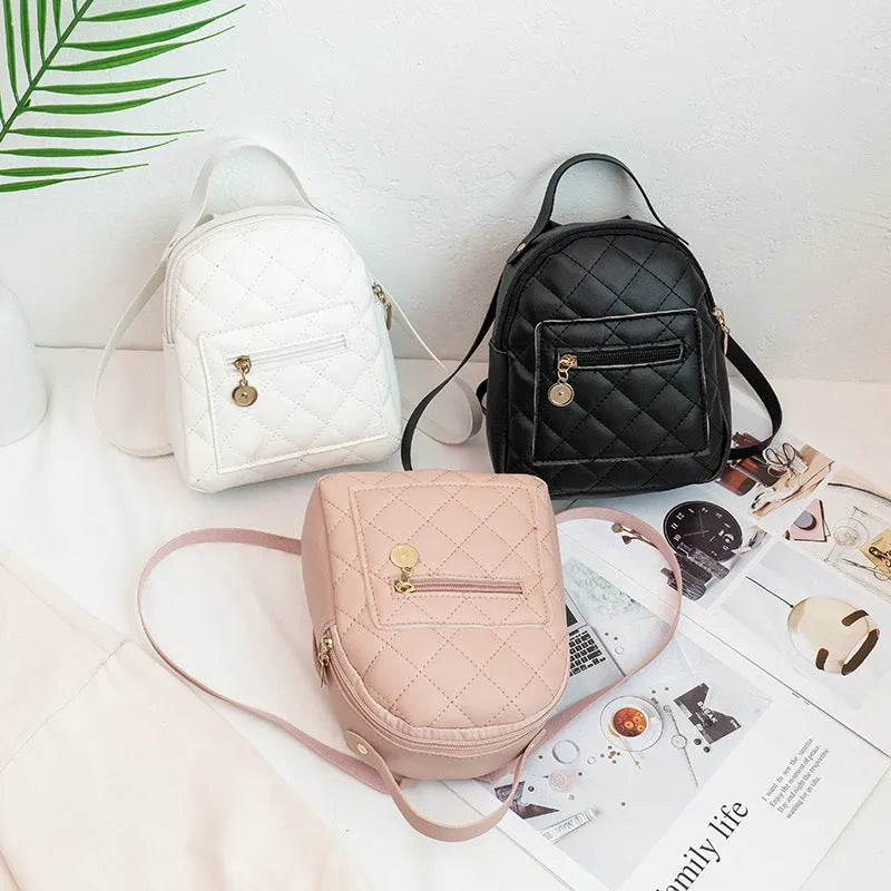 Girls' square hard PU backpack with embroidery, soft handle, in white, black, or pink.
