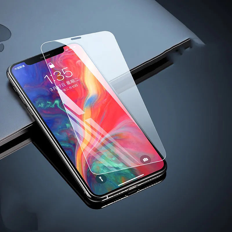 Tempered glass screen protector for Apple iPhone models on a clean surface.