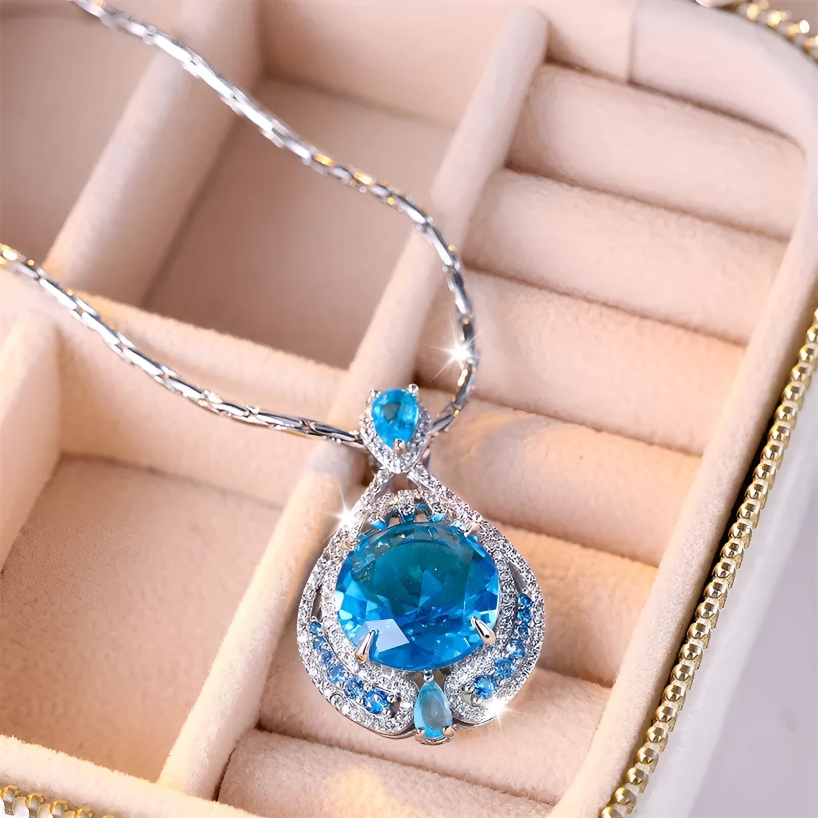 Geometric women's necklace with blue fireworks-cut crystal gems on a water wave chain.