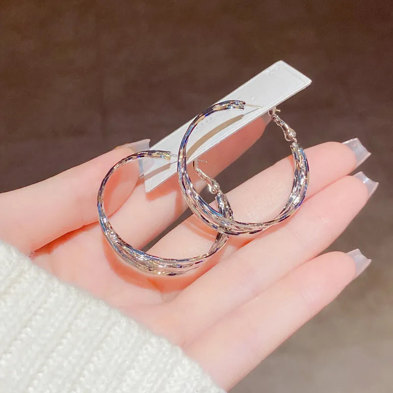 Silver Needle fashion simple metal twisted earrings in gold electroplated finish on copper base, round geometric shape