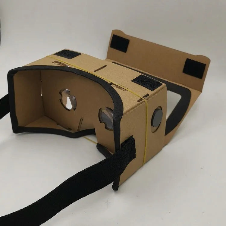 Pink and white cardboard VR glasses for smartphones with 3D lenses and a rubber strap.