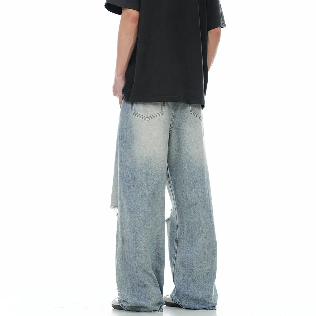 Blue retro-style men's straight-leg jeans with distressed detailing on a solid background