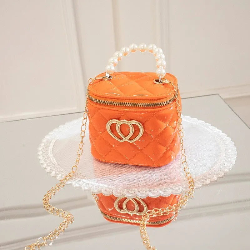Women's PVC bucket gel bag with heart-shaped pattern in assorted colours.