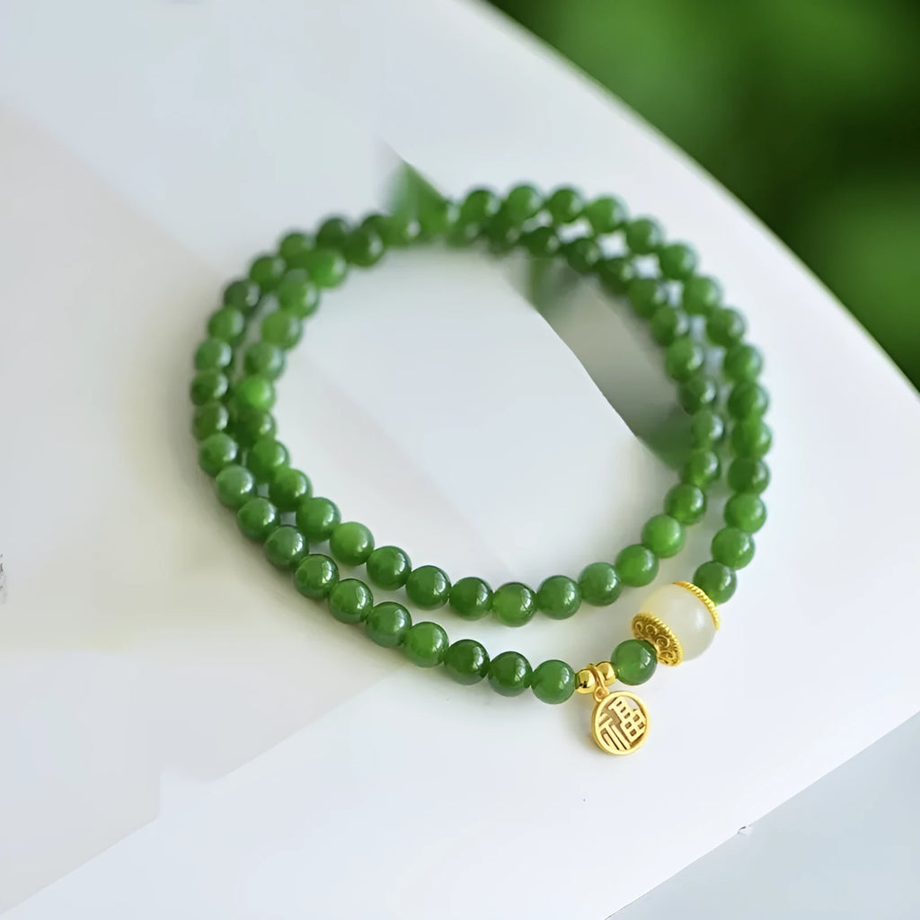 Women's double circle bracelet made of natural Hetian jade featuring a fu character symbol.