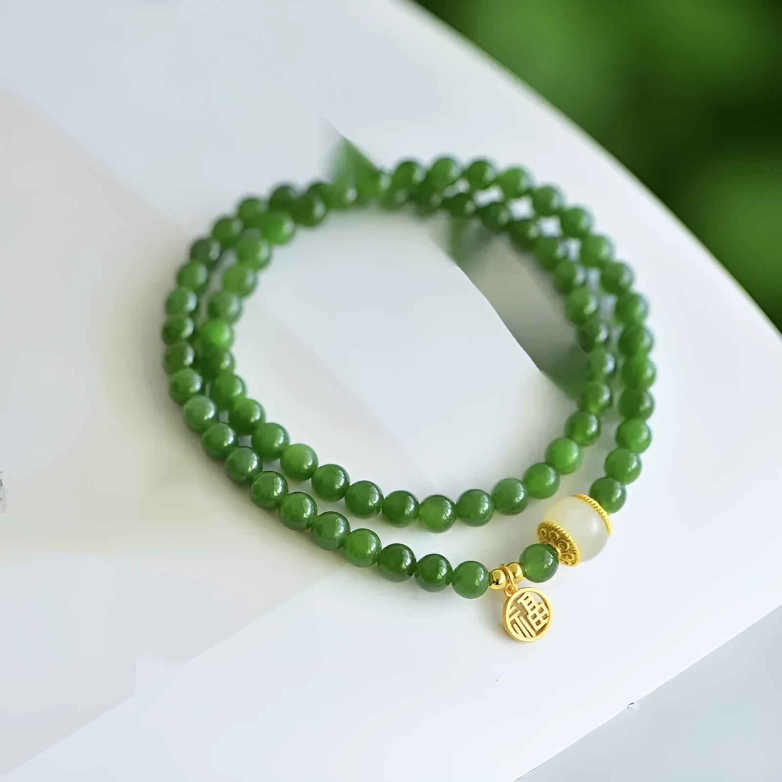 Women's double circle bracelet made of natural Hetian jade featuring a fu character symbol.