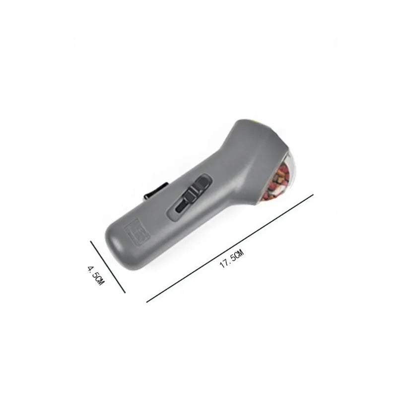 Grey dog training snack launcher catapult showing spring trigger mechanism and compact 18cm design