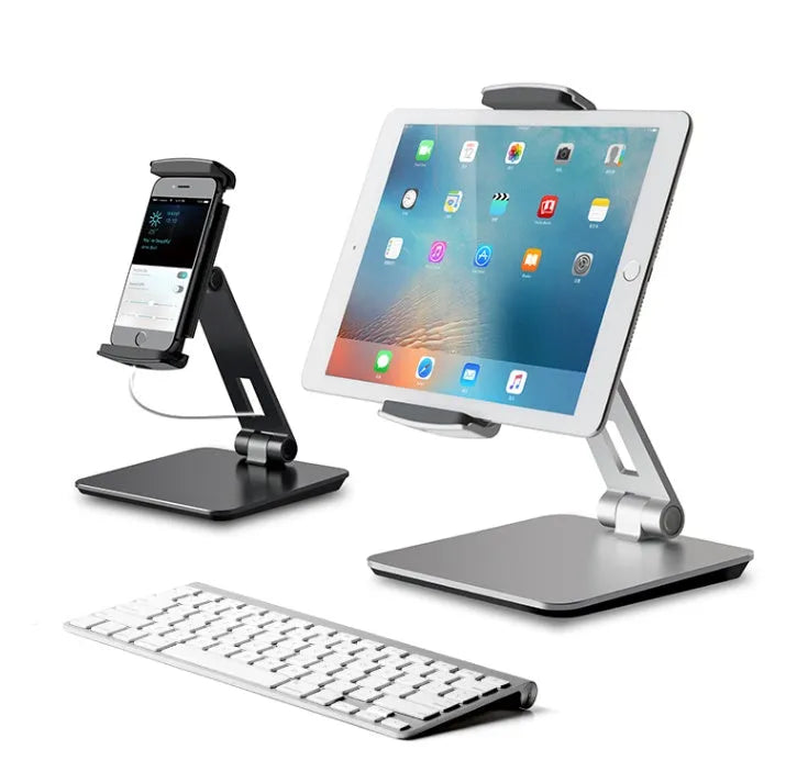 Folding aluminium phone and tablet stand with black silicone pads, shown holding a tablet at an angle.