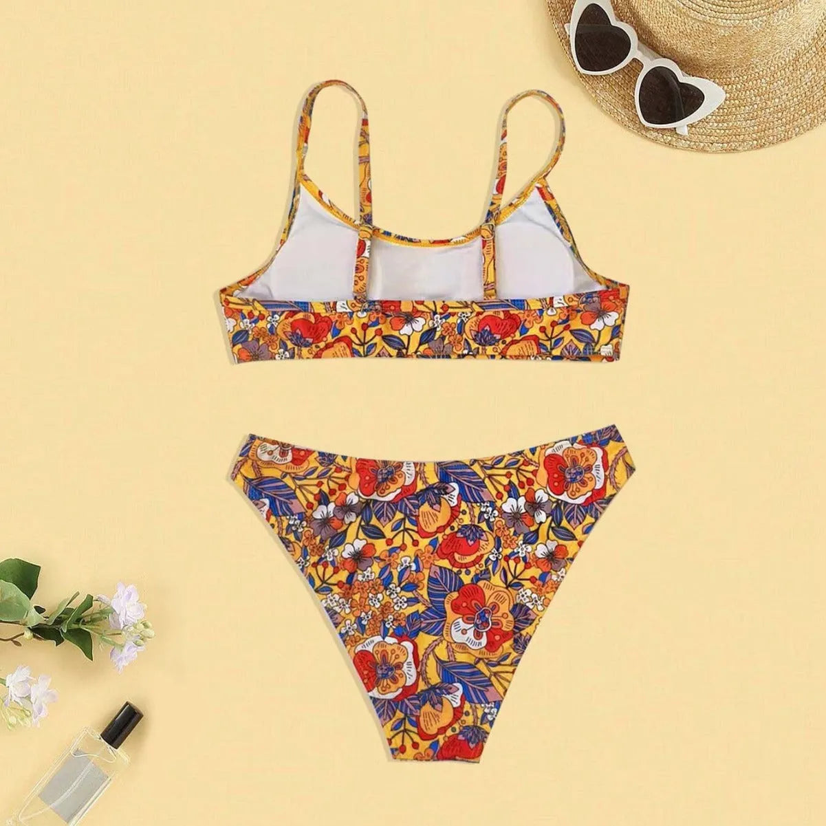 Plus size women's floral print strap bikini swimsuit two-piece set on a mannequin