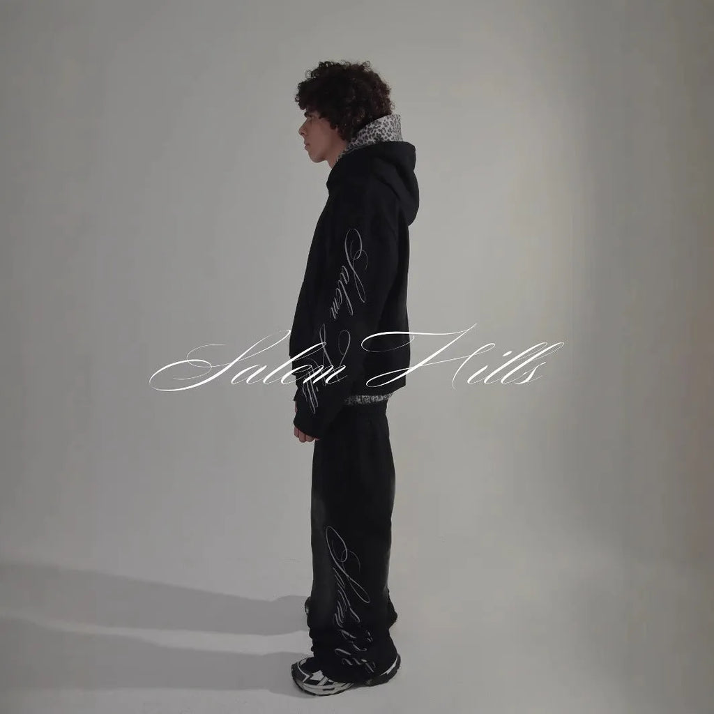Adult male punk print hoodie and pants leisure suit set in fleece-lined polyester.