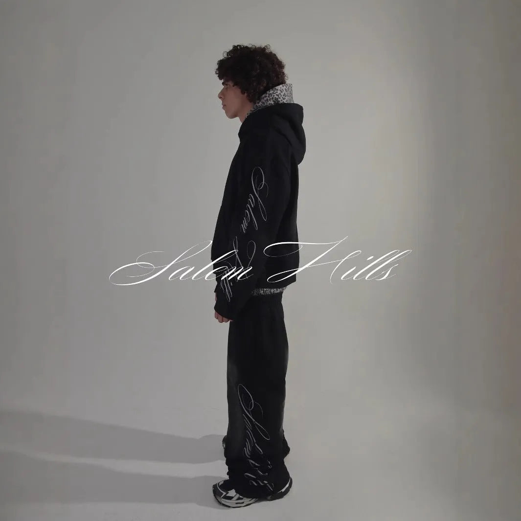 Adult male punk print hoodie and pants leisure suit set in fleece-lined polyester.