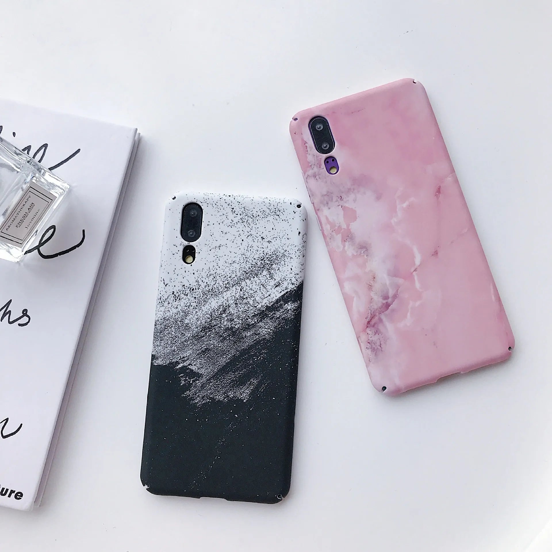 Black painted hard back phone case for Huawei models on a white background.