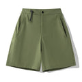 Man wearing army green quick-dry sports shorts with an elastic waistband for running or climbing.