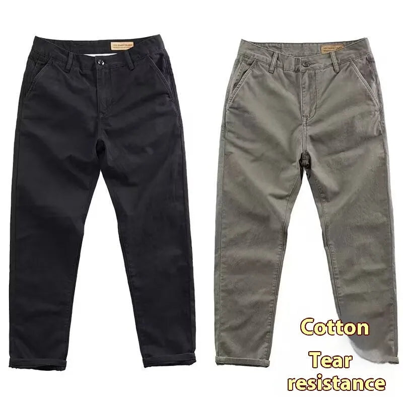 Man wearing slim fit straight-leg casual trousers in a grey washed fabric, showing business gentleman style.
