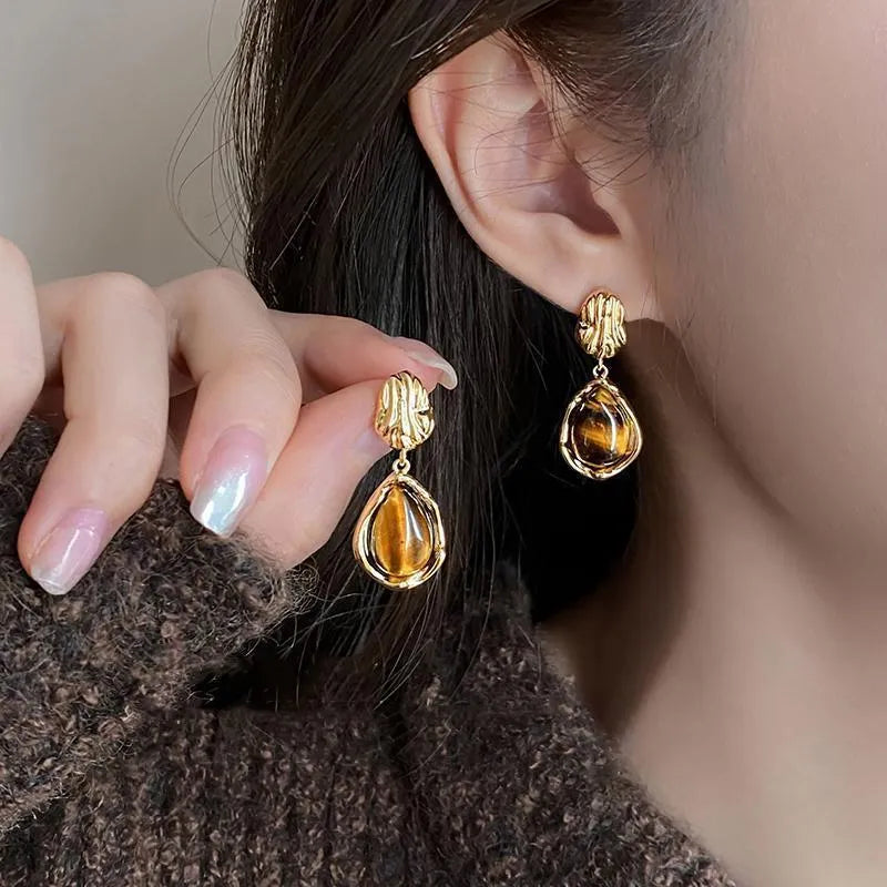 Three pairs of handmade geometric earrings with electroplated alloy construction and tassel detailing