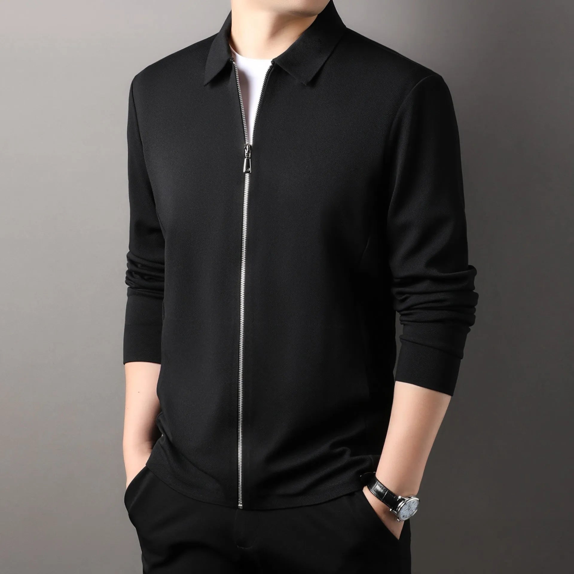 Men's black polyester jacket with long sleeves and a straight hem on a hanger.