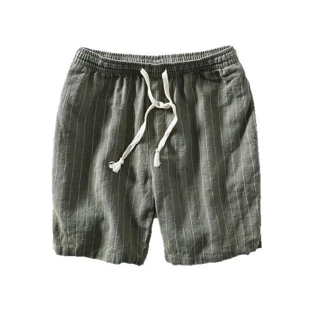 Man wearing grey striped cropped casual trousers with an elastic waistband, showing the straight-leg summer streetwear style.