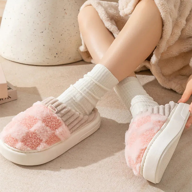 Plaid pattern women's slippers with plush lining and a light-coloured non-slip PVC sole, shown in a grey colour option.