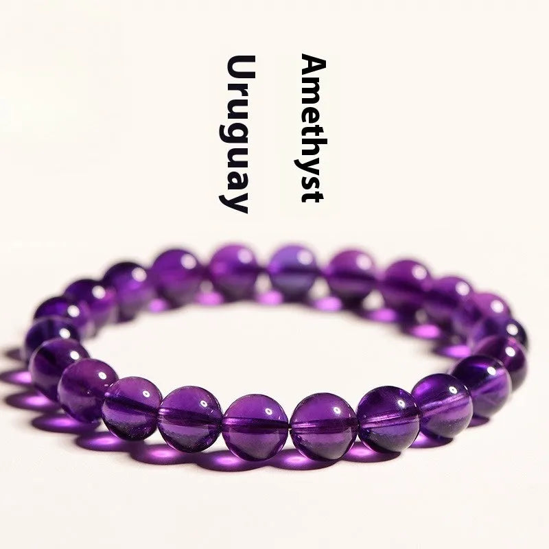 Natural Uruguayan amethyst crystal bead bracelet with polished scattered beads on a white background.