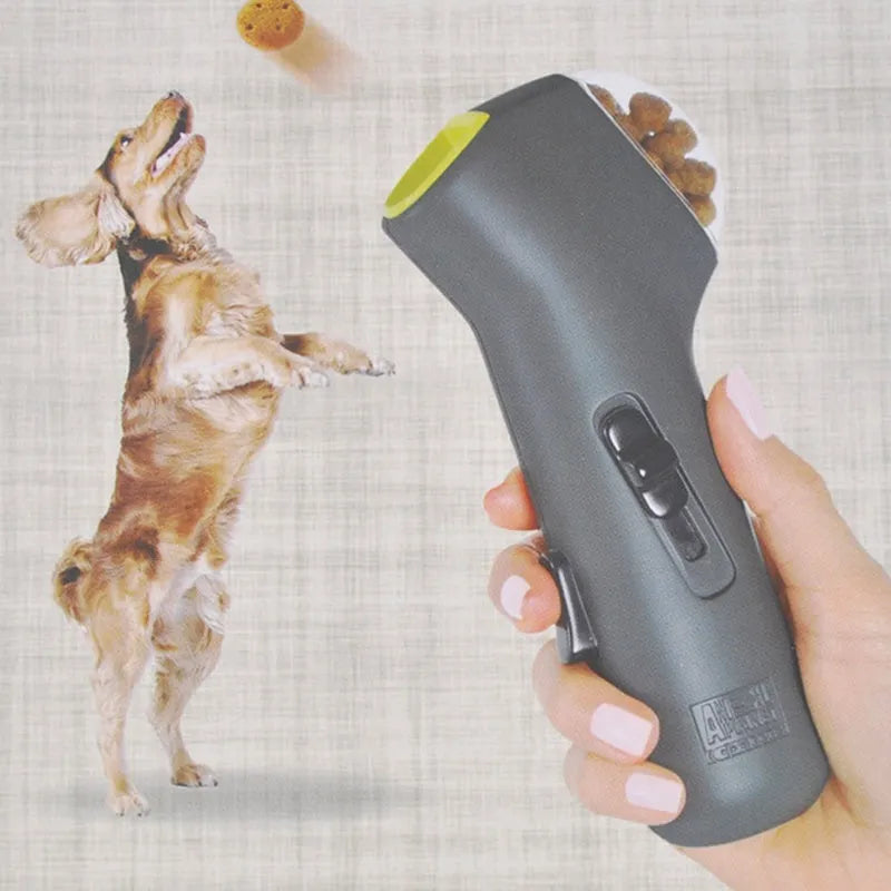 Grey dog training snack launcher catapult showing spring trigger mechanism and compact 18cm design