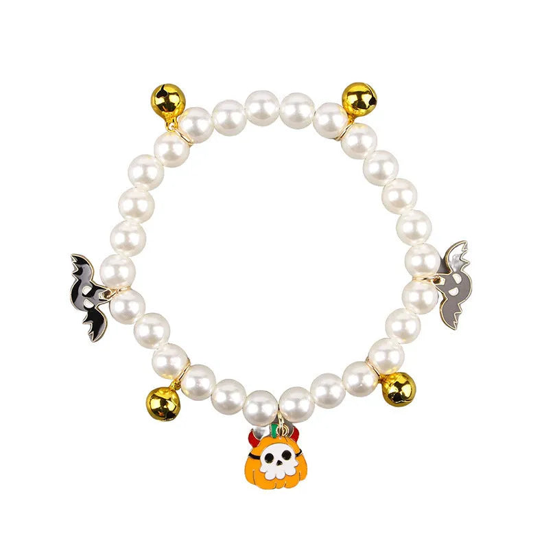 Halloween cat collar with simulated pearl necklace decoration showing pumpkin designs including purple ghost, skull, and smiling pumpkin patterns