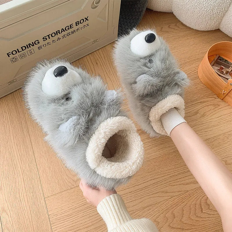 Grey ankle wrap slippers with a plush upper and a non-slip rubber sole, shown on a wooden floor.