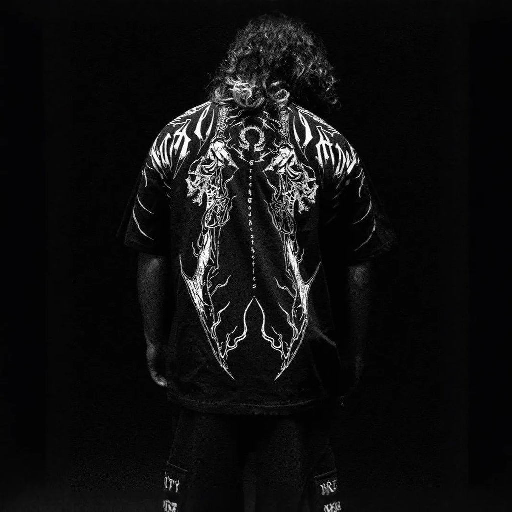 Man's loose-fit dark cotton t-shirt with short sleeves and metallic gilding detail on the front.