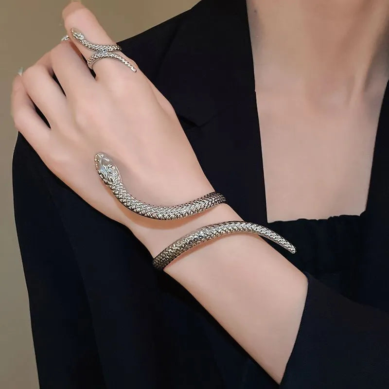 Gold and silver snake-inspired ring and bracelet set with twisted winding design