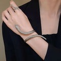 Gold and silver snake-inspired ring and bracelet set with twisted winding design