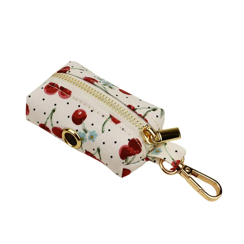 Red cherry print dog collar set with matching leash, vest, and light gold buckle