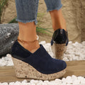 Women's wedge heels in black suede and leather patchwork with round toe and back zipper closure.