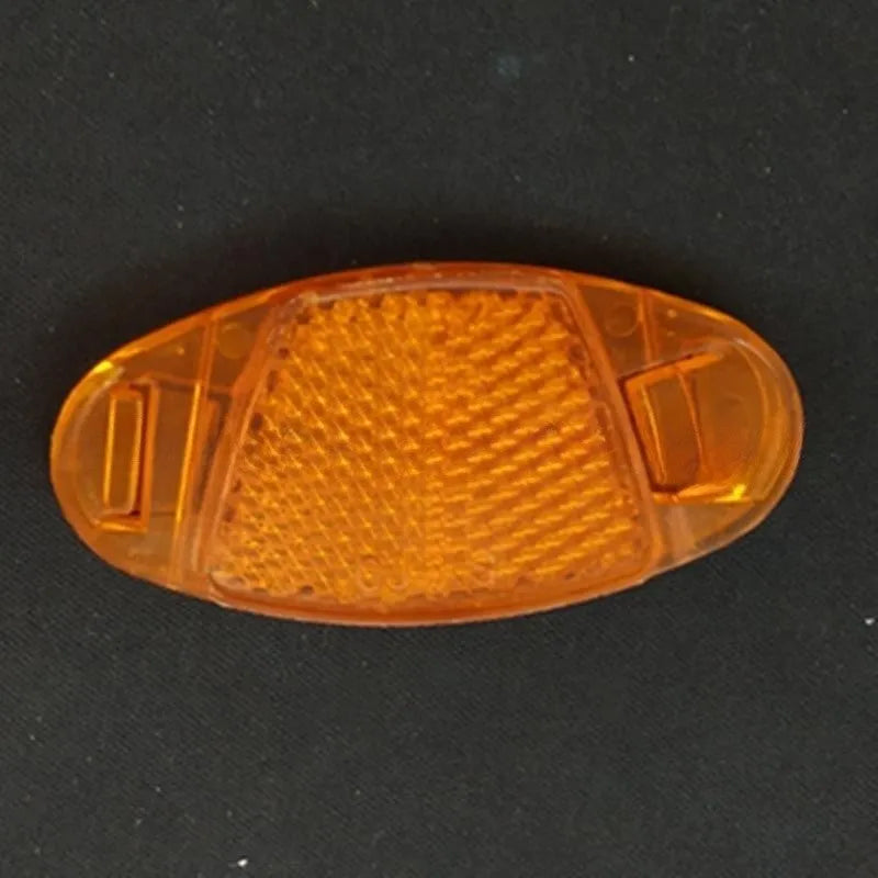 Bicycle spoke reflector decoration in white or yellow measuring 7.2cm by 3.5cm