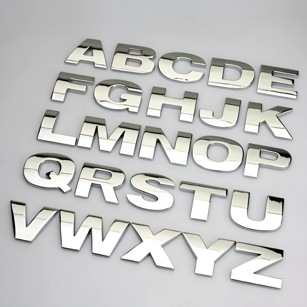 3D metal zinc alloy car letter sticker in black or silver, shown actual size at 2.5cm.