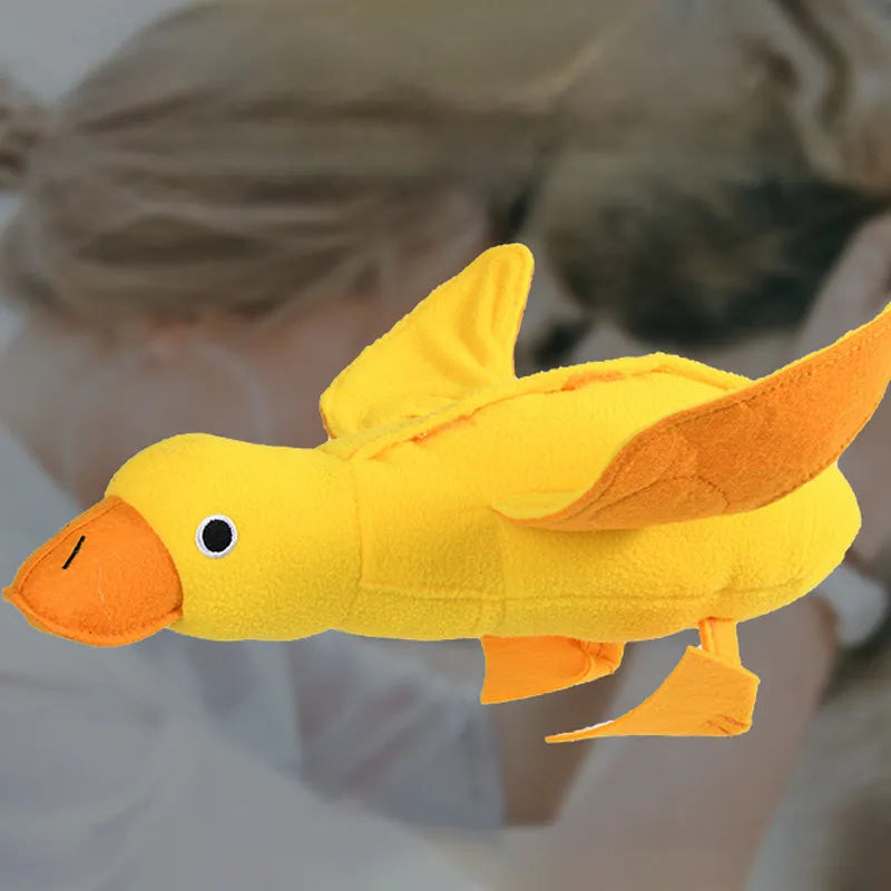 Yellow plush teddy bear dog toy with an attached duck doll, featuring a squeaker and treat compartment.