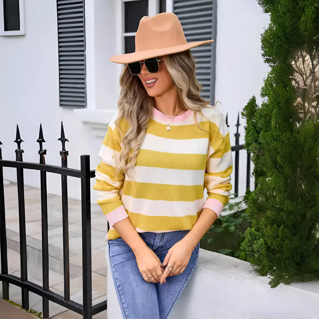 Women's loose fit acrylic knit sweater in blue with striped pattern, long sleeves and round neck.