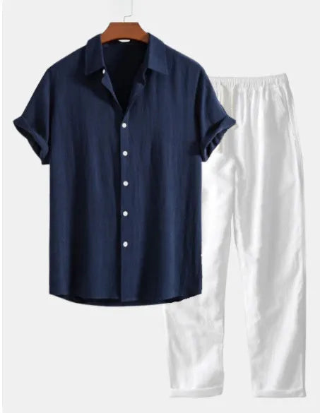 Men's navy blue casual short sleeve cotton linen suit with matching trousers, glasses, shoes, and watch on a hanger.
