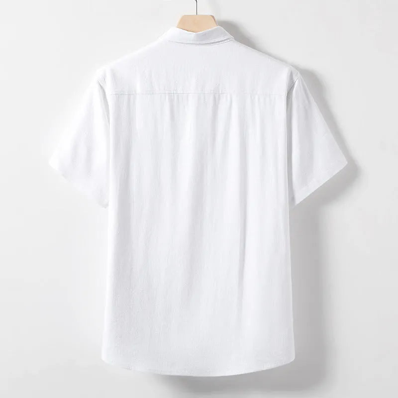 A man wearing a loose-fit, solid colour linen blend t-shirt with short sleeves.