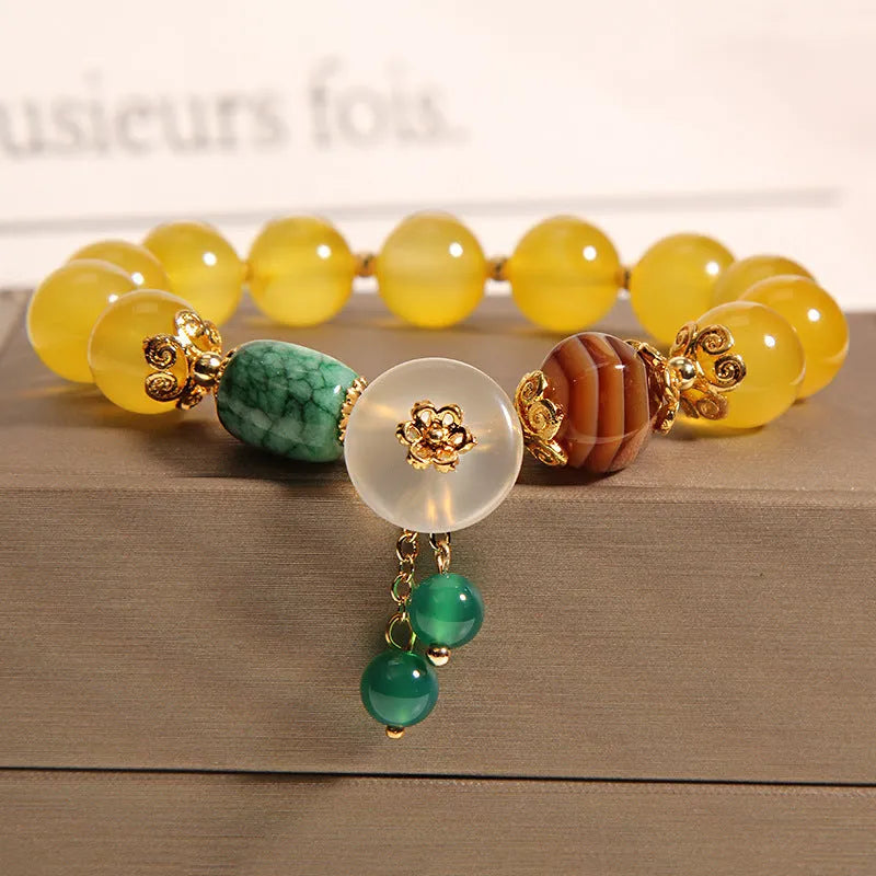 Women's adjustable crystal bracelet with yellow agate stones and gold silk thread.