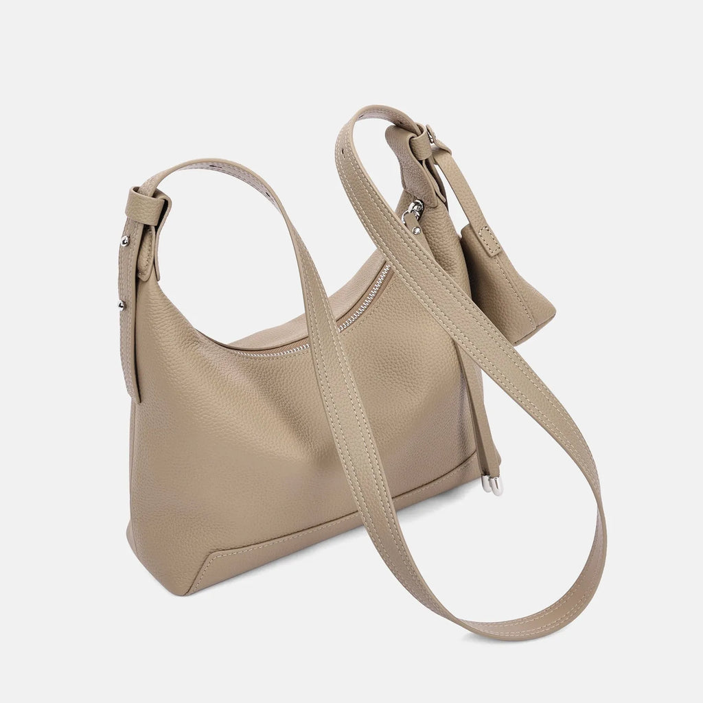 Simple black cowhide leather ladies shoulder bag with visible stitching and urban style design