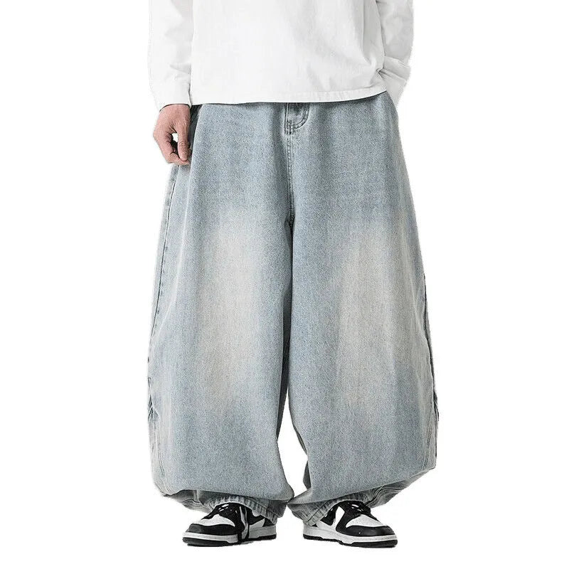 Man wearing light blue baggy fit denim jeans with a straight leg and low waist.