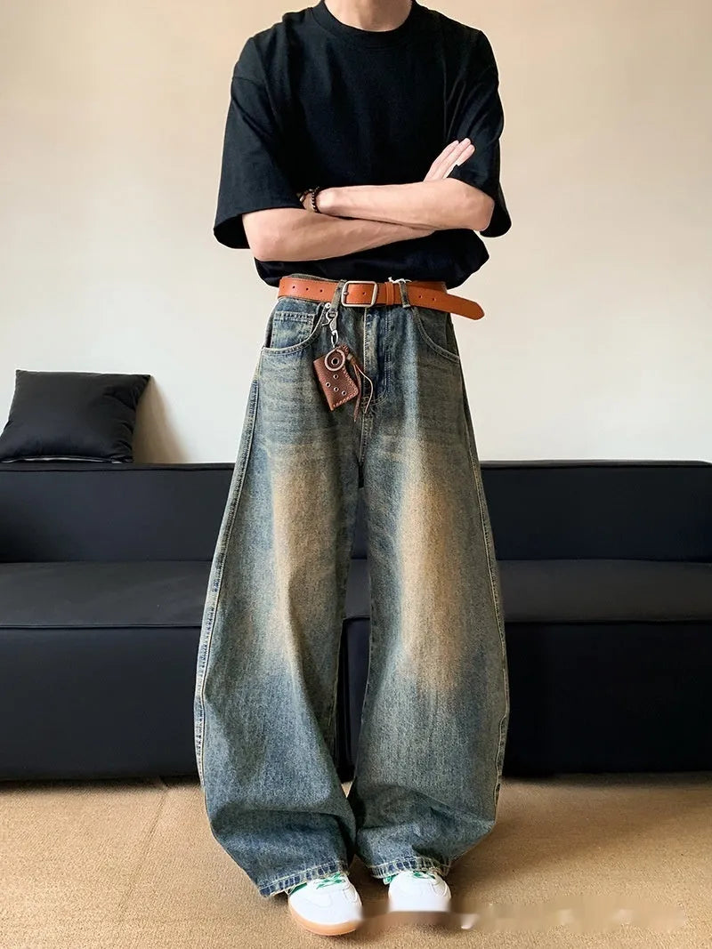 Man wearing retro blue distressed wide-leg denim jeans with machete detailing